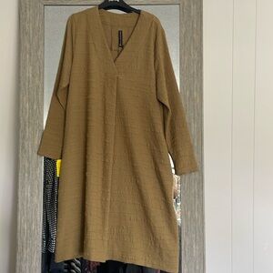 dress color is mustard has a great V-neck with the pleat coming down the middle